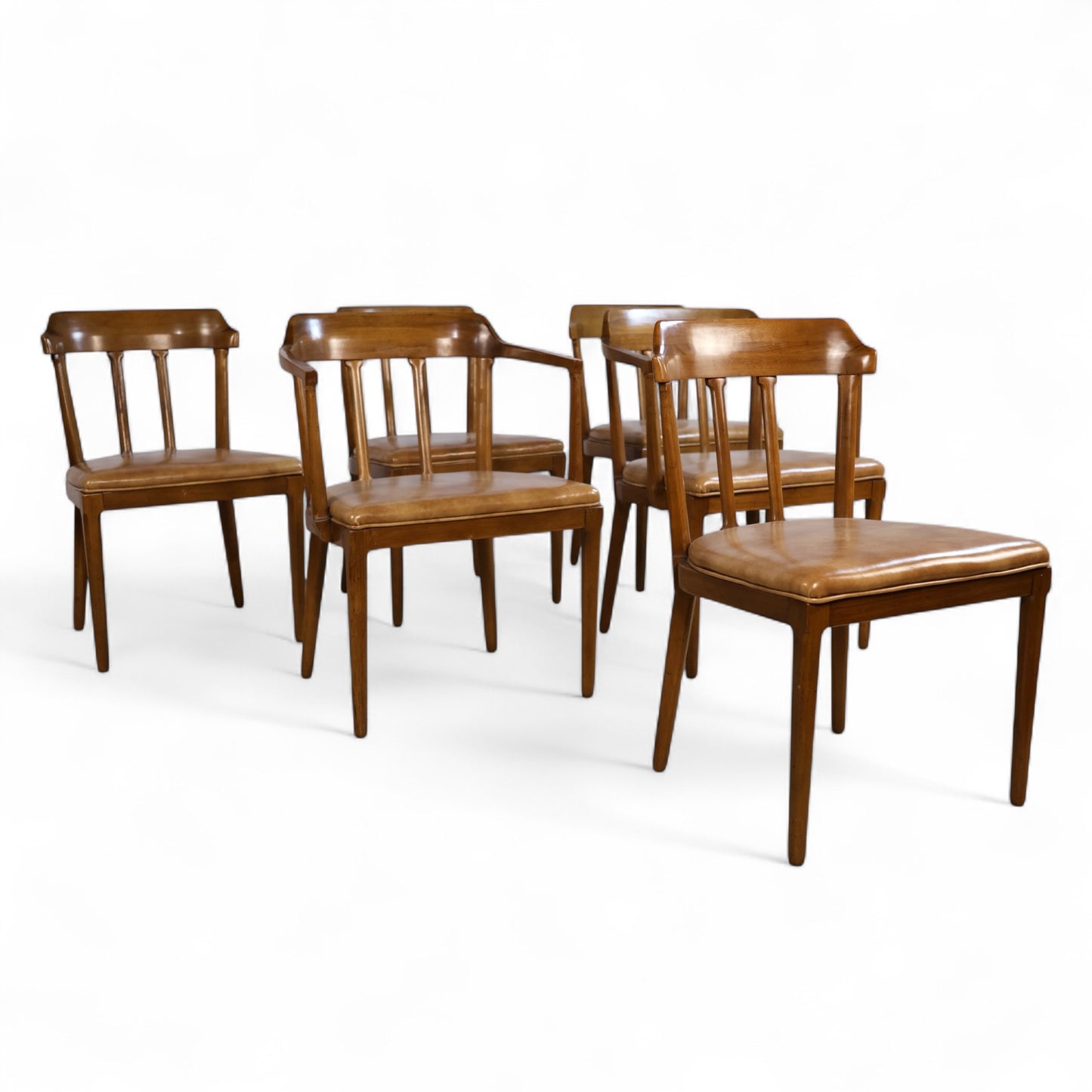 Set of six vintage Tomlinson dining chairs with sculpted walnut frames and caramel vinyl seats, including armchairs and side chairs
