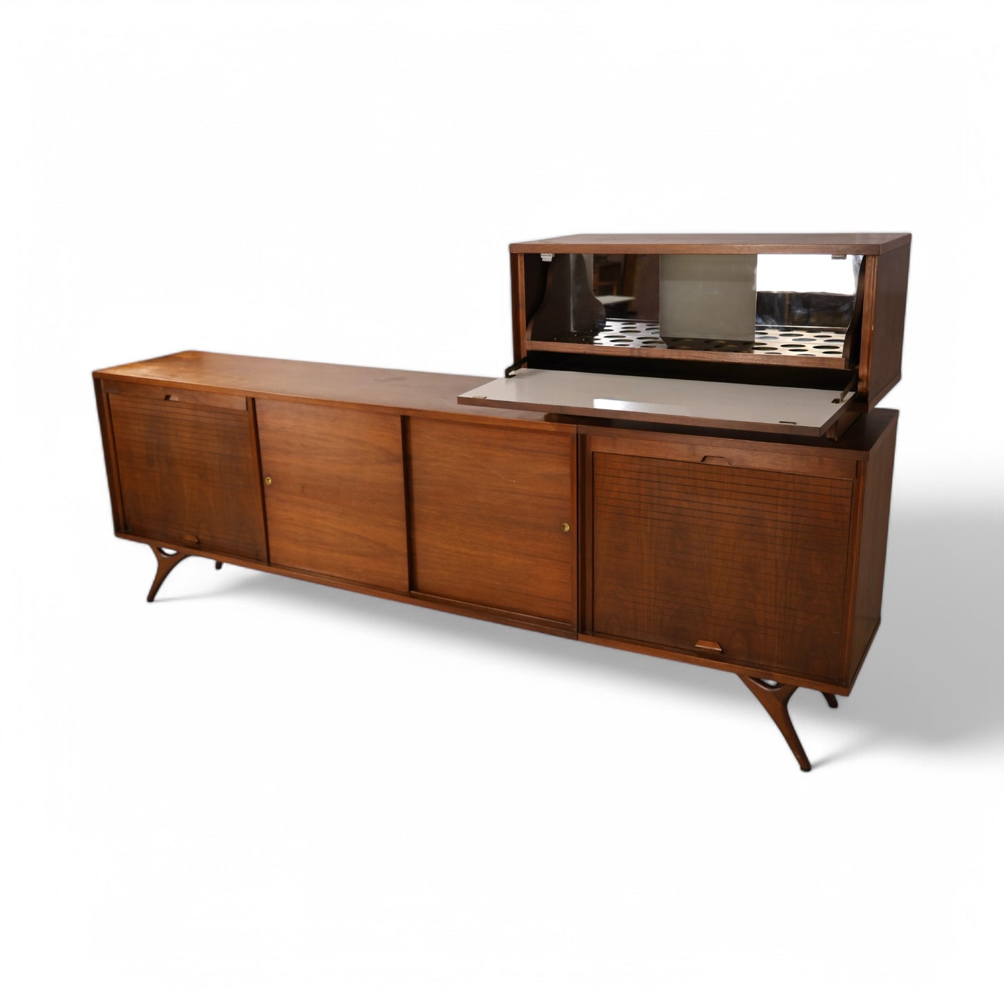 Sculptural Mid Century Modern credenza with rich walnut grain and brass hardware