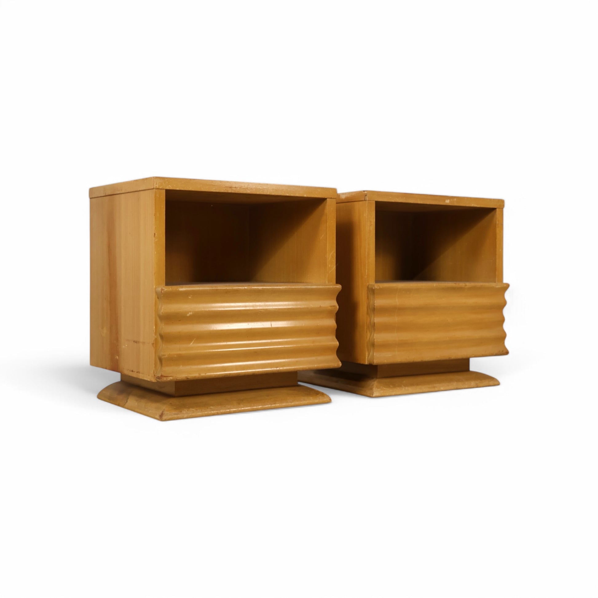 Vintage birch nightstands with ribbed drawer fronts and recessed platform bases