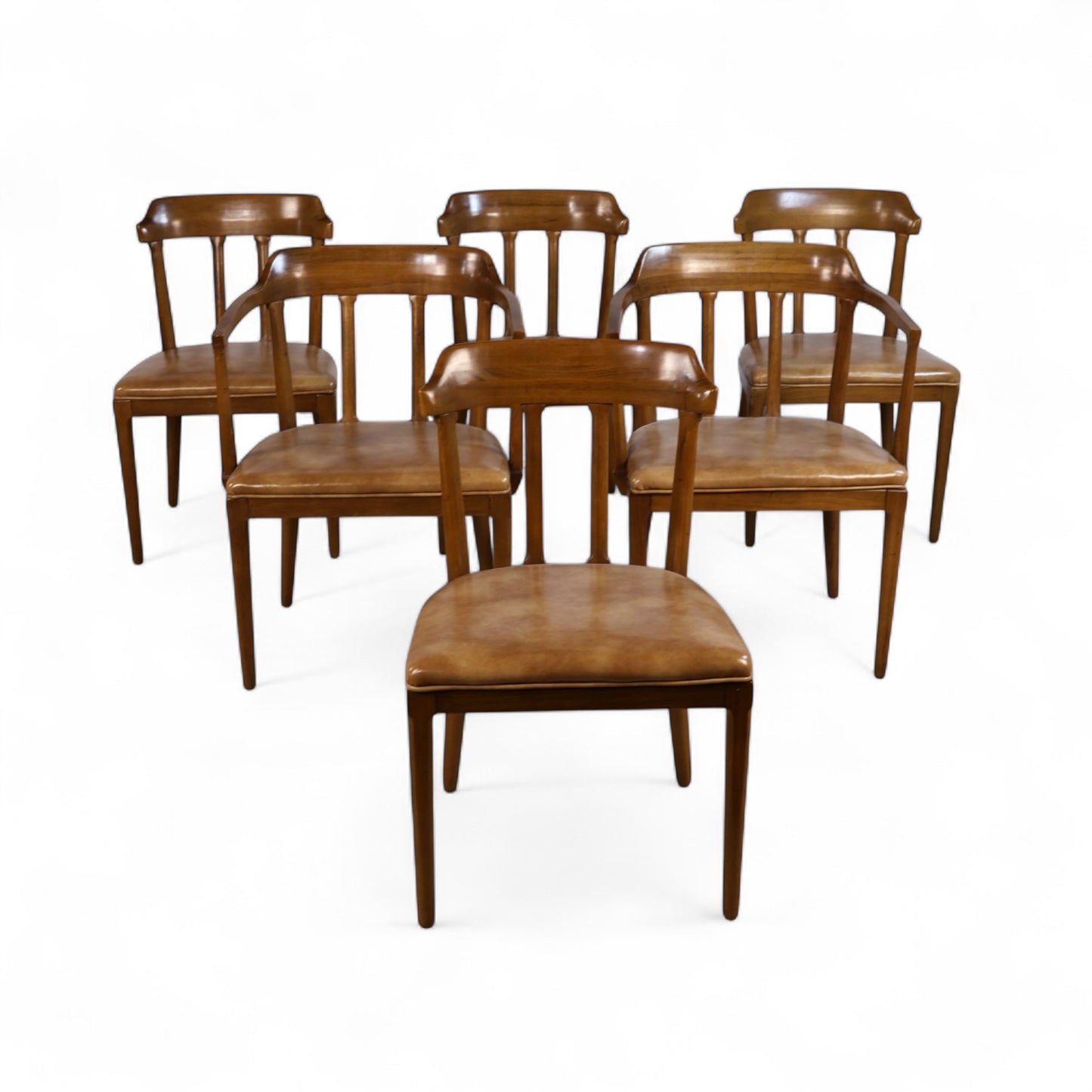 Close-up of Tomlinson armchair with curved backrest, angular arms, and warm-toned wood grain finish