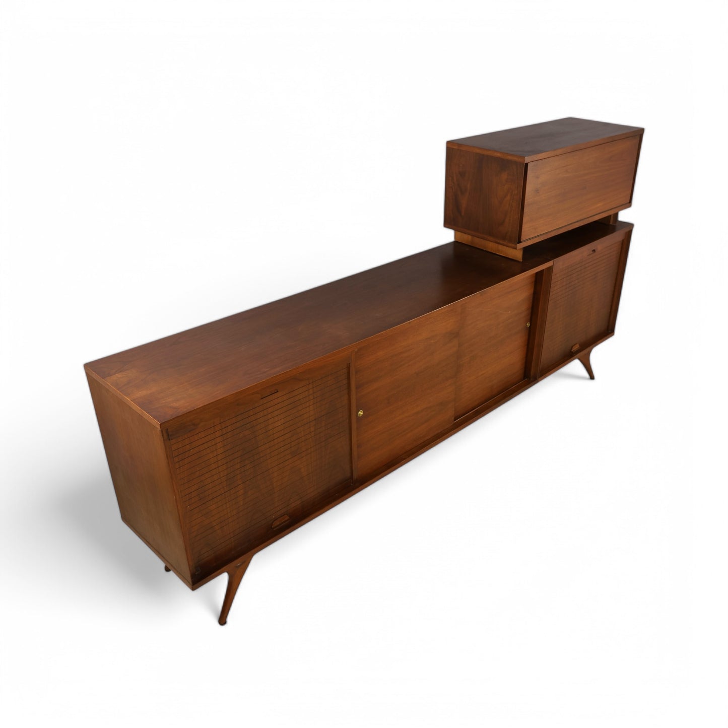 Side view of credenza showing sweeping profile and sculpted walnut legs