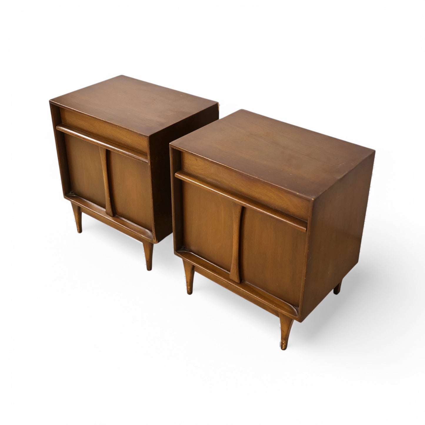 Walnut nightstands with curved door details and minimalist mid-century lines