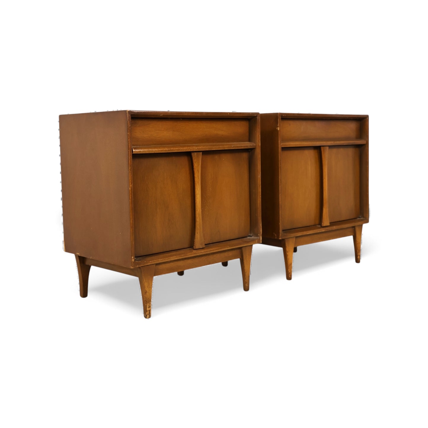 Mid-century modern nightstands with tapered legs and compact proportions