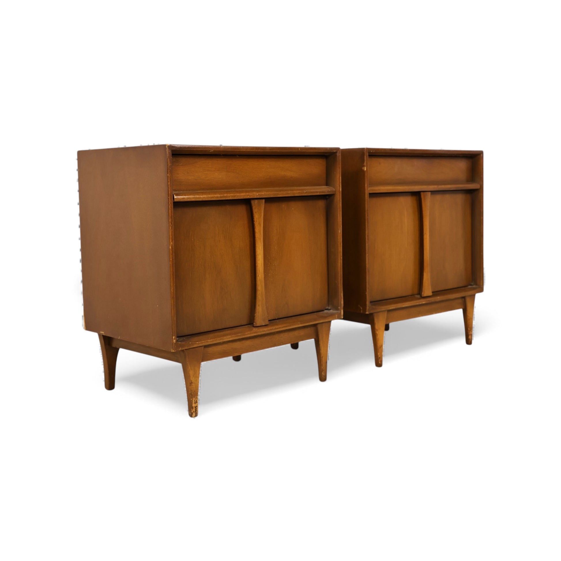 Mid-century modern nightstands with tapered legs and compact proportions