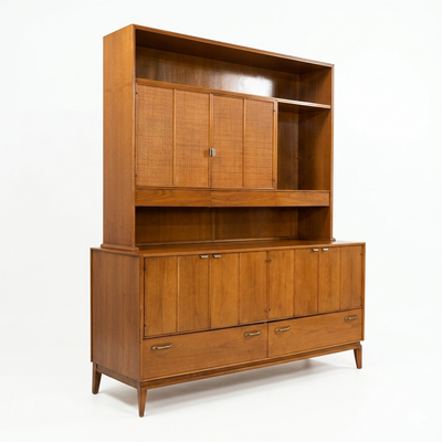 Red Lion MCM walnut two-piece china cabinet, full front view showing hutch with cane panel sliding doors and open top shelf over buffet base with four doors and two drawers, tapered legs, c. 1960s