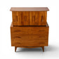 Young Manufacturing sculptural highboy dresser angled front view showing flared crown top and splayed legs