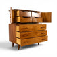Young Manufacturing sculptural highboy angled open view showing interior drawers and carved door backs