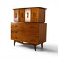 Young Manufacturing sculptural highboy dresser opposite angle view showing walnut grain and sculpted base