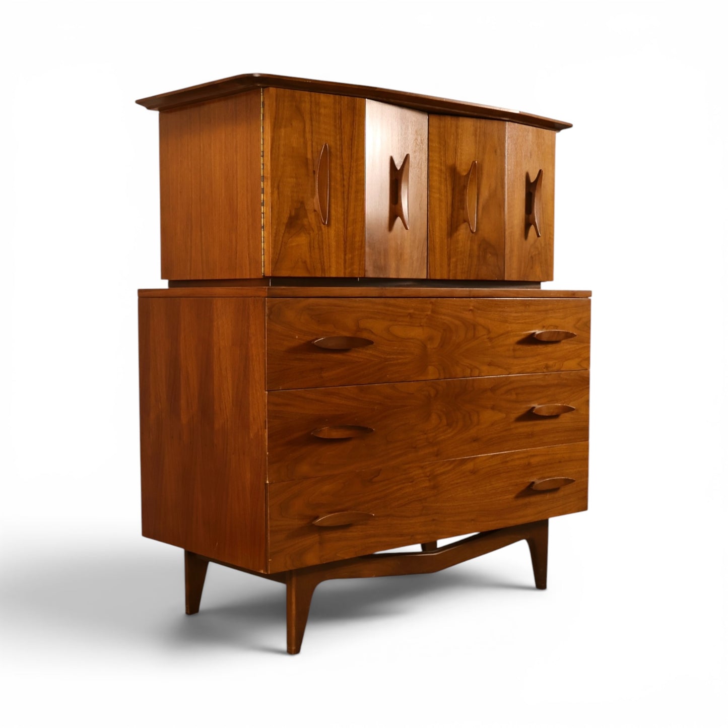 Young Manufacturing sculptural highboy dresser angled view showing carved upper doors and oval pulls