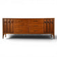 Kent Coffey Perspecta walnut 12 drawer lowboy dresser front view with carved arched door panels and sculpted pulls