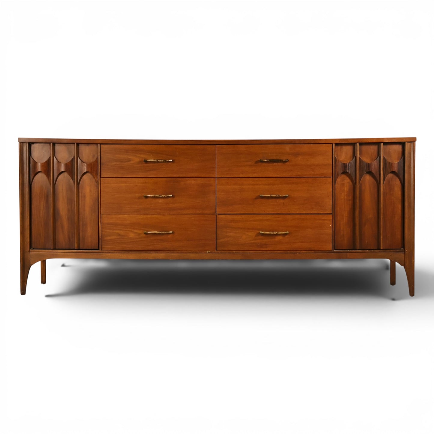 Kent Coffey Perspecta walnut 12 drawer lowboy dresser front view with carved arched door panels and sculpted pulls