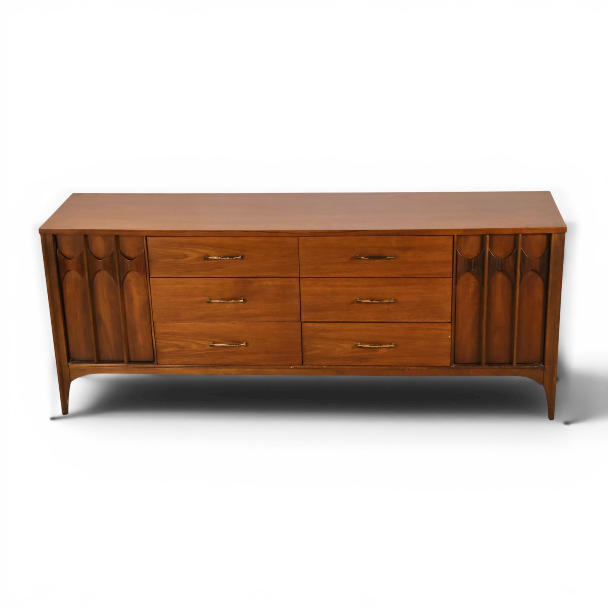 Kent Coffey Perspecta lowboy dresser angled front view showing sculpted arch relief doors and splayed legs