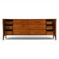 Kent Coffey Perspecta lowboy dresser with sculpted doors open revealing concealed banks of three drawers