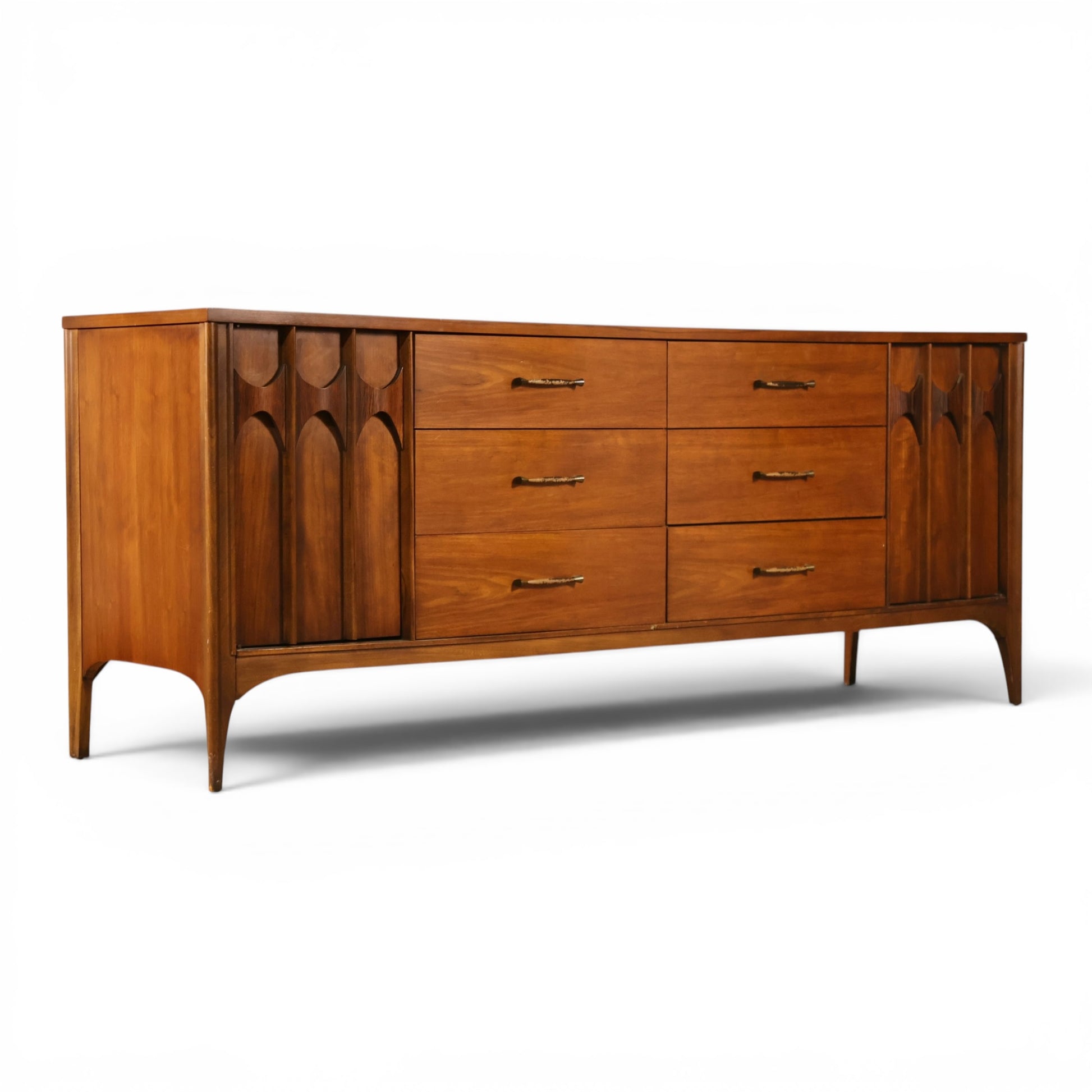 Kent Coffey Perspecta walnut lowboy dresser angled view showing carved door detail and walnut grain top