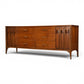 Kent Coffey Perspecta walnut lowboy dresser three quarter view showing carved arch door panels