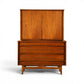 Young Manufacturing walnut concave highboy dresser front view with book matched cabinet doors and three concave drawers
