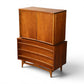 Young Manufacturing highboy dresser angled view showing concave top edge and horizontal drawer shadow lines