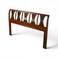 Kent Coffey Perspecta headboard angled view showing bowed top rail and carved panel depth