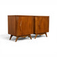 Young Manufacturing pair of nightstands angled front view showing sculpted aprons and splayed legs