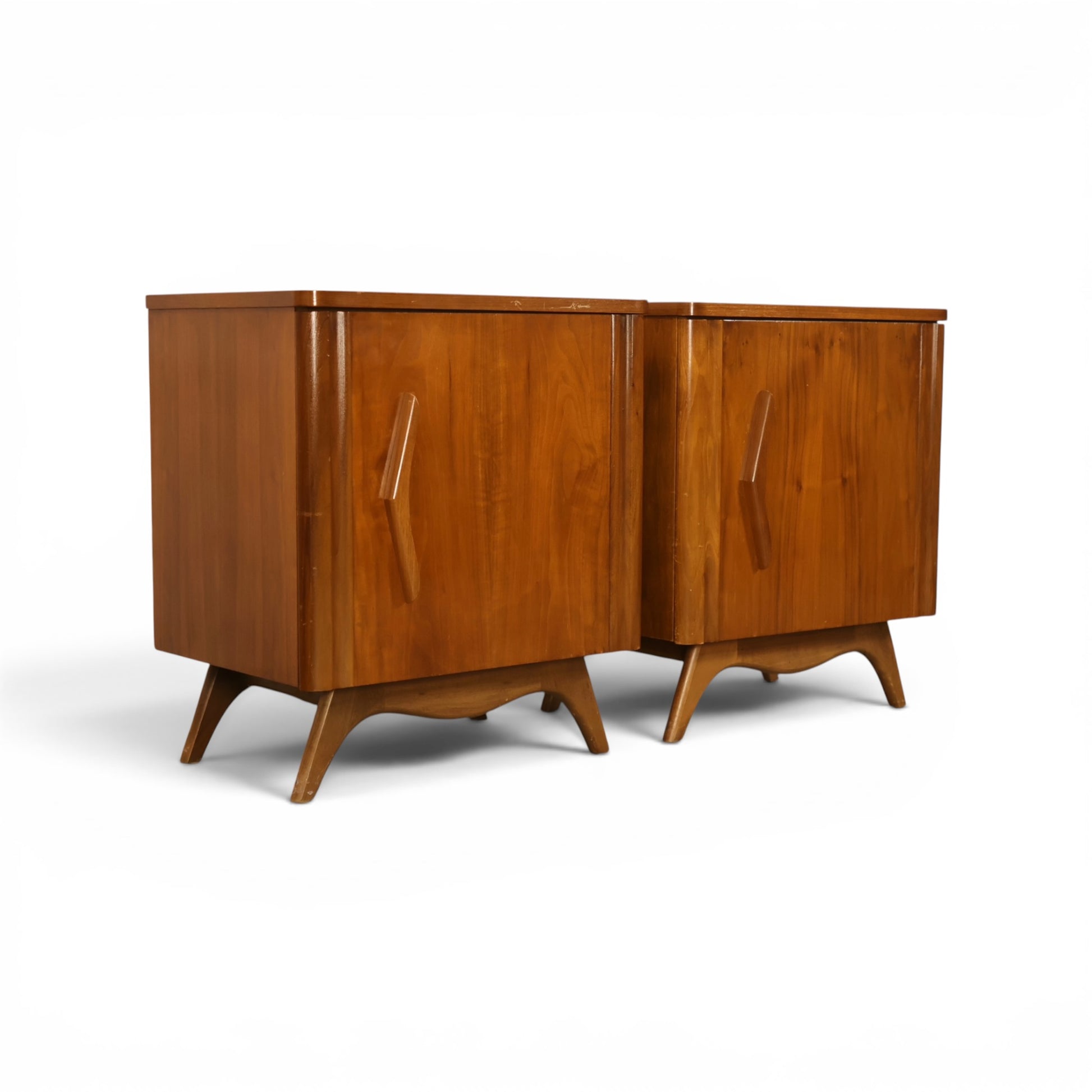 Young Manufacturing pair of nightstands angled front view showing sculpted aprons and splayed legs