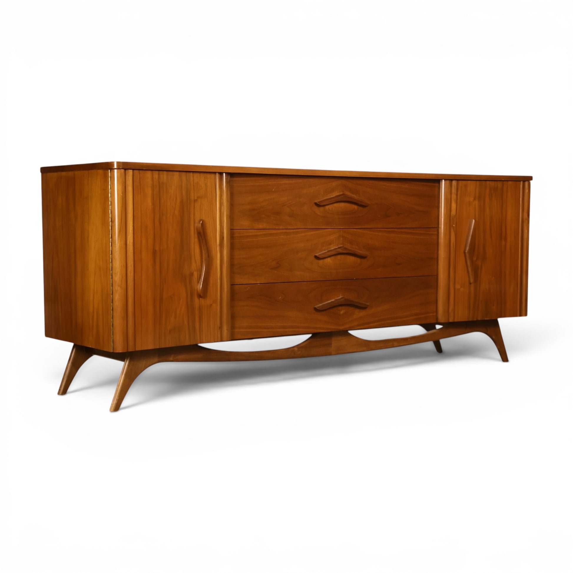 Young Manufacturing sculptural lowboy dresser angled view showing carved vertical door pulls