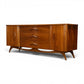 Young Manufacturing sculptural lowboy dresser angled front view showing sculpted legs and stretcher