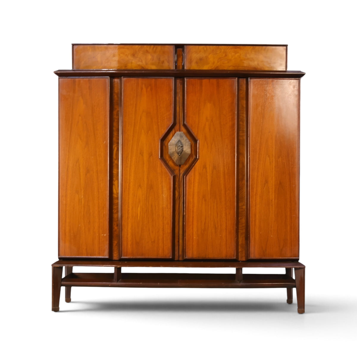 Helen Hobey Baker burl and walnut highboy dresser front view with sunburst brass pull