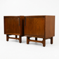 Cavalier Furniture MCM walnut nightstands, matching pair front view with doors closed showing sculpted arched stretcher bases, walnut grain, and brass vertical pulls, c. 1960s