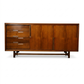 Cavalier Furniture MCM walnut lowboy dresser, front view with sliding door panels open revealing 4 center drawers with recessed bar pulls and flanking cabinet storage, c. 1960s