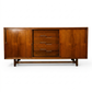 Cavalier Furniture MCM walnut lowboy dresser, front view with sliding door panels open revealing 4 center drawers with recessed bar pulls and flanking cabinet storage, c. 1960s