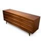 Young Manufacturing MCM walnut lowboy dresser, 3/4 right-side angle showing side profile and tapered legs, c. 1960s