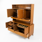 Red Lion MCM walnut two-piece china cabinet, 3/4 view with left hutch door open showing cane panel back and interior shelf, buffet fully open revealing velvet-lined compartments and file storage, c. 1960s