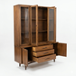 Broyhill Sculptra MCM walnut two-piece china cabinet, all doors open and drawers extended showing interior storage, hutch shelves, and Sculptra carved panel doors flanking center drawers, c. 1960s