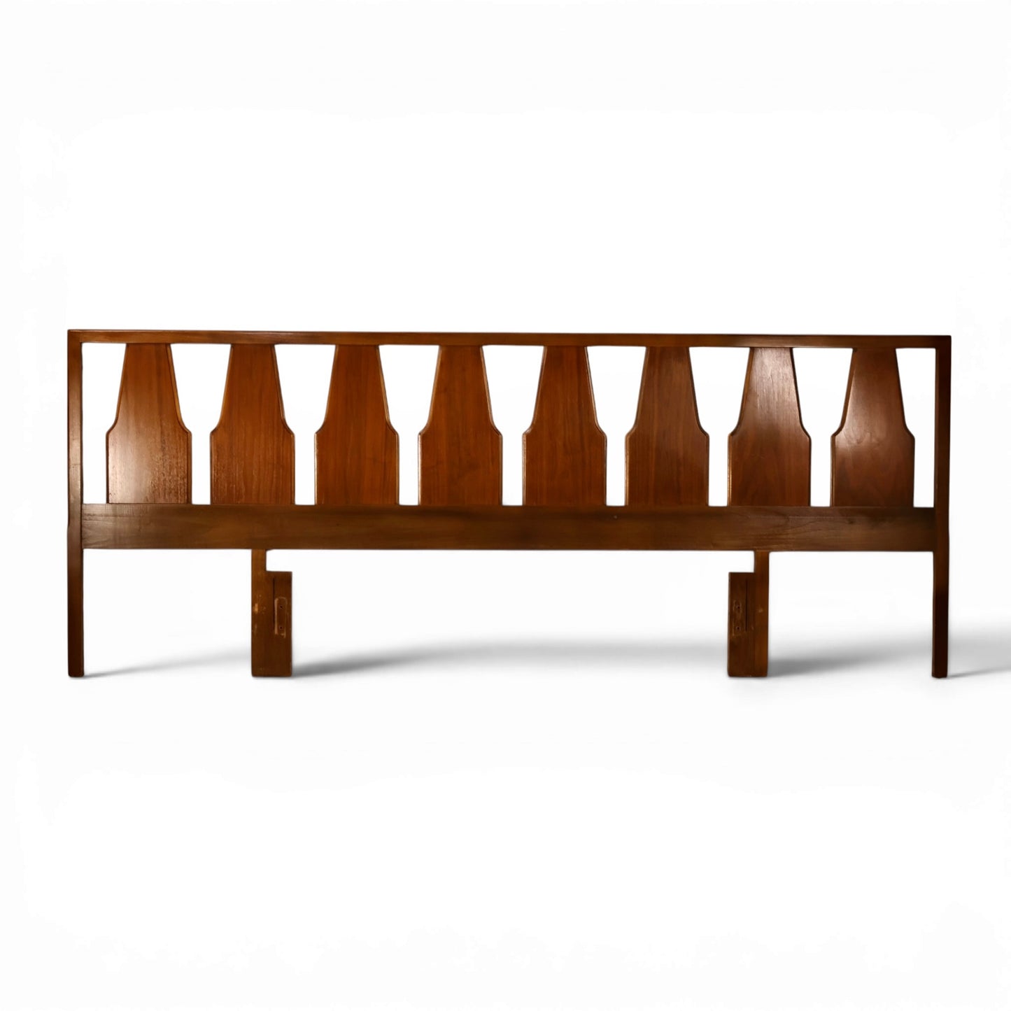 Young Manufacturing sculptural walnut king headboard with shaped spindles front view