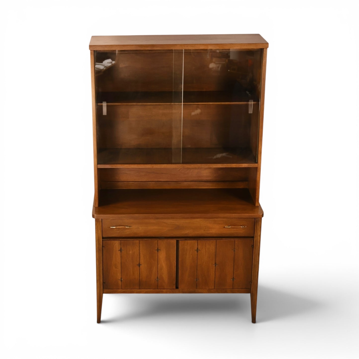 Broyhill Saga petite china cabinet straight front view on tall tapered legs