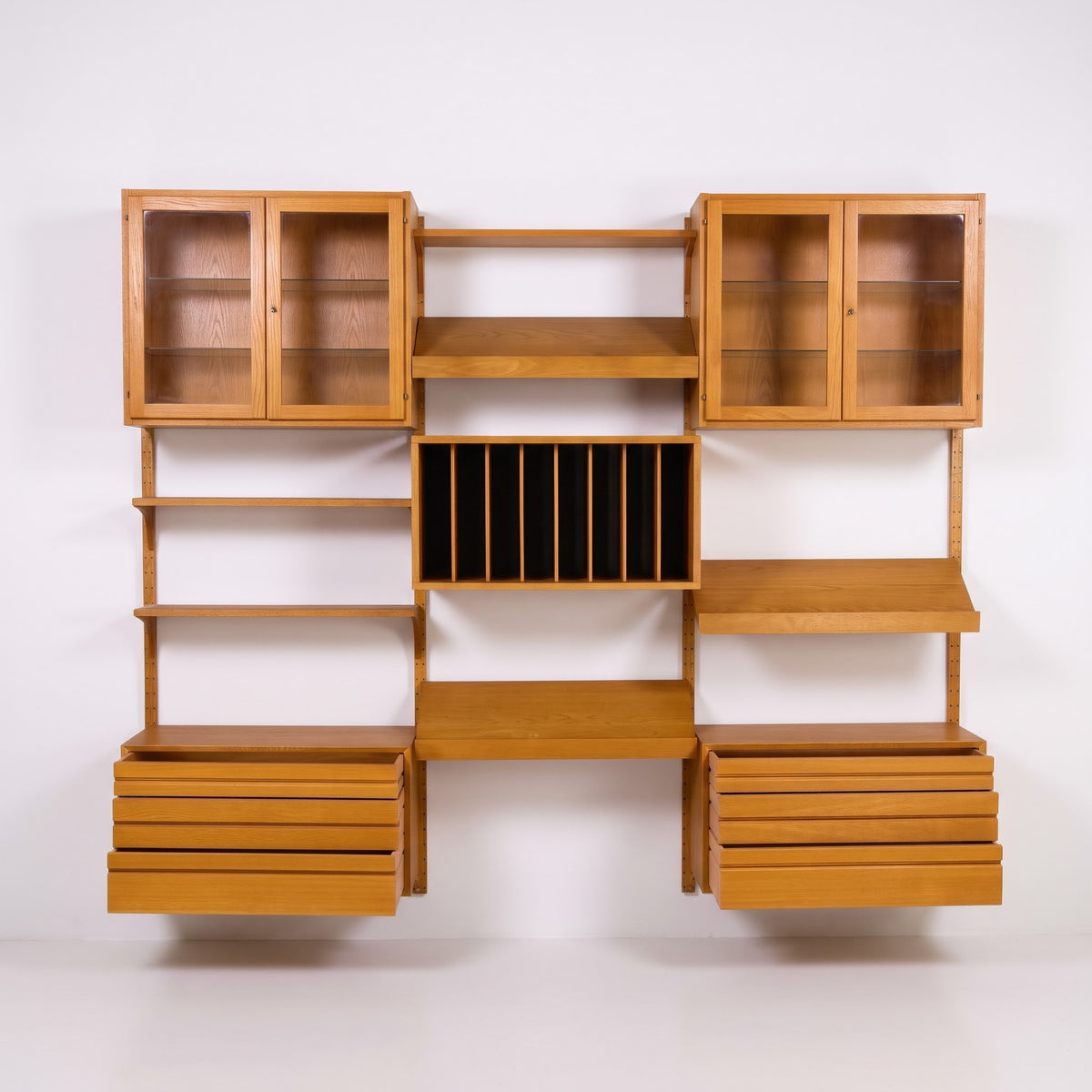 Poul Cadovius Cado wall unit front view with glass display cabinets, record divider cabinet, and slanted shelves