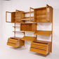 Poul Cadovius Cado oak wall unit angled view with open glass cabinets and drawers