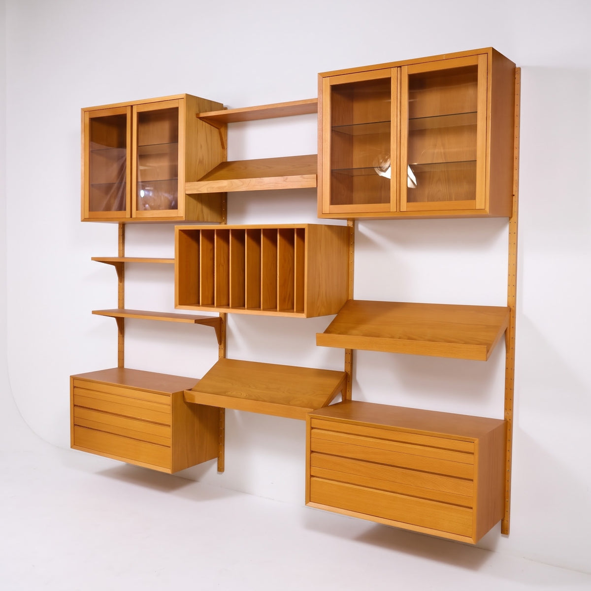 Poul Cadovius Cado System oak wall unit angled view with glass door cabinets and floating drawer cabinets