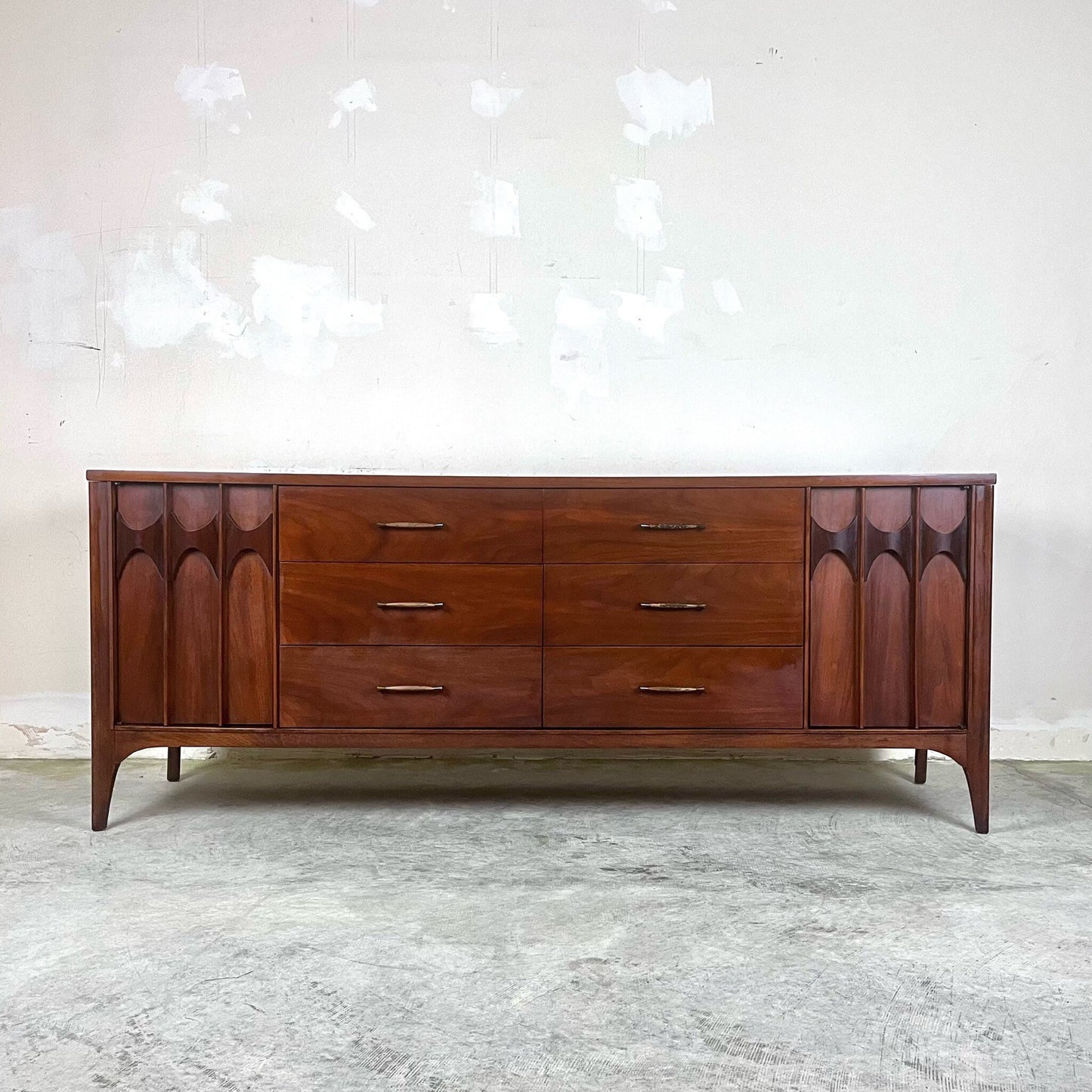 Kent Coffey Perspecta dresser with sculpted wooden doors and brass handles