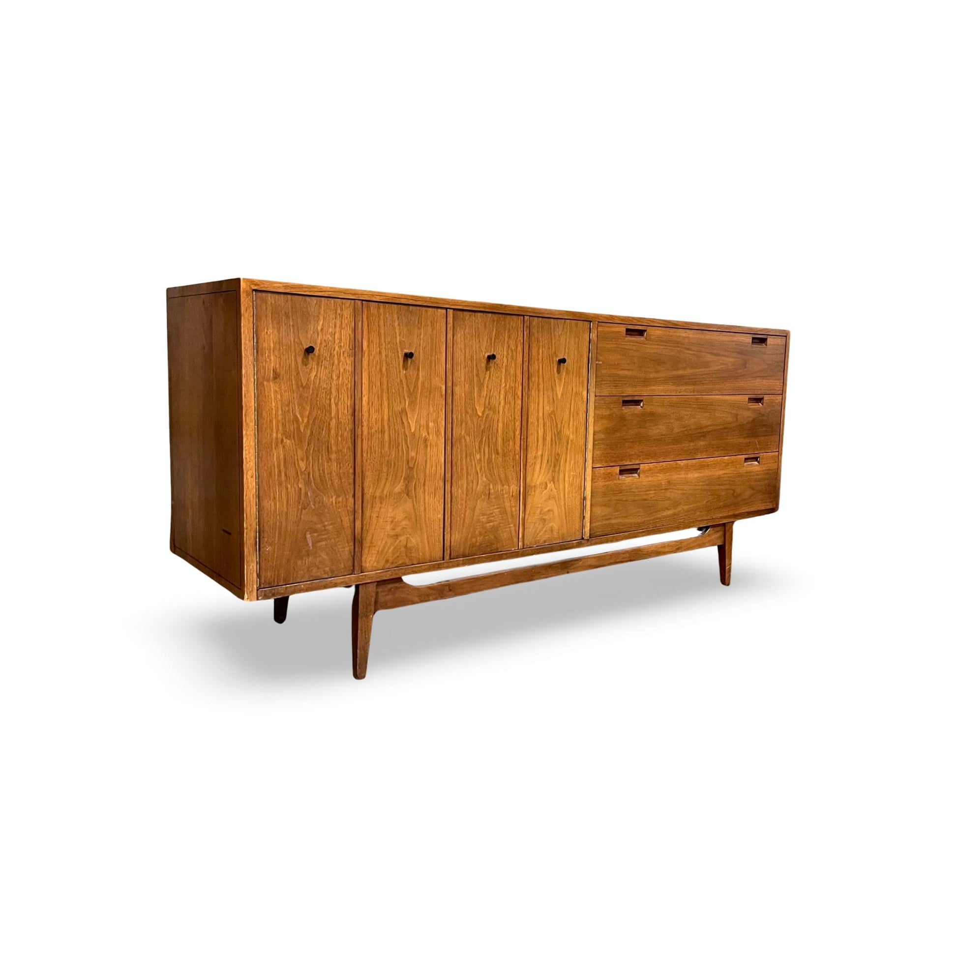 Mid-century Modern walnut dresser with concealed and accessible drawers.