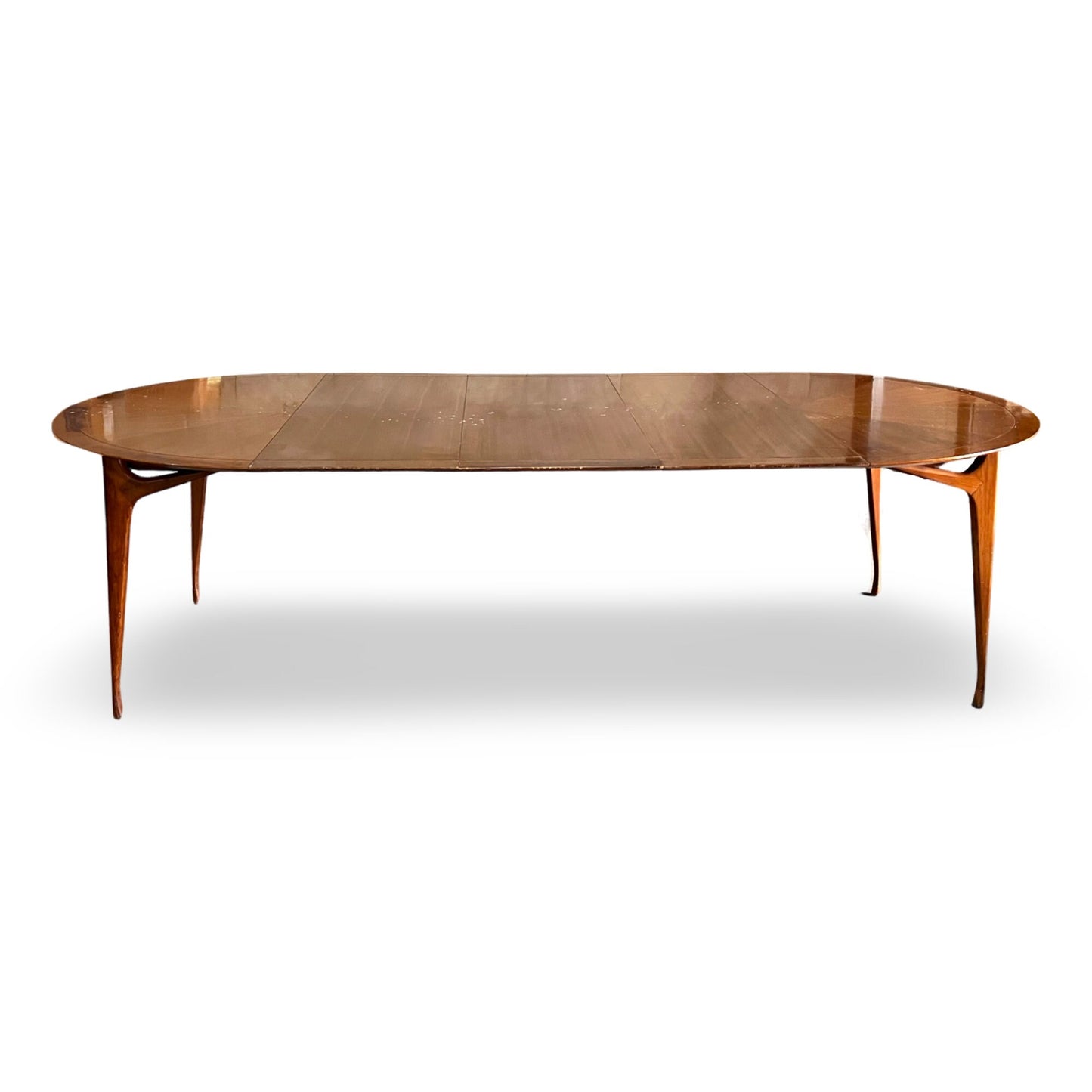Sleek MCM dining table with sculpted legs, ideal for gatherings of 10+.