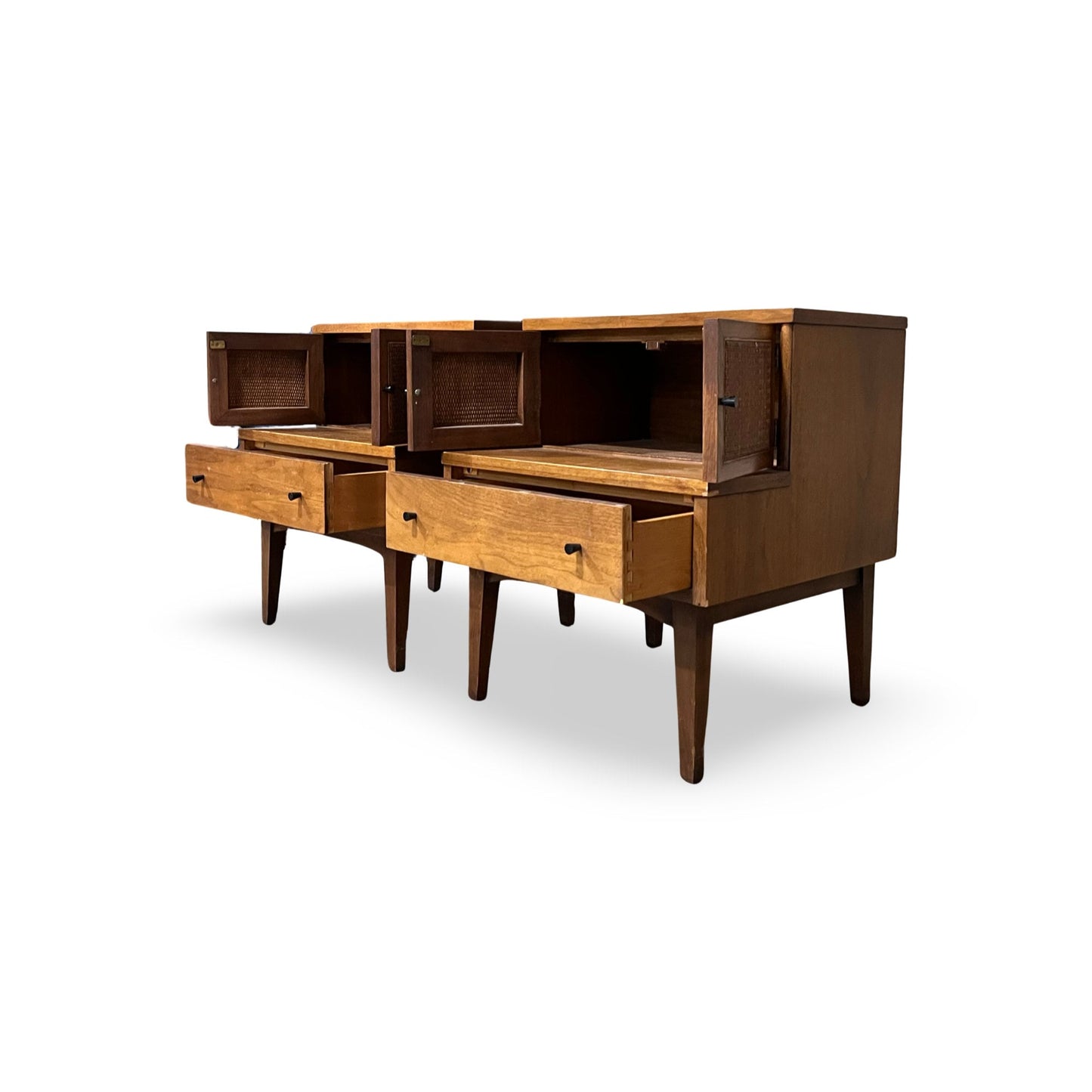 Stylish nightstands with splayed legs and brass knobs, offering ample storage.